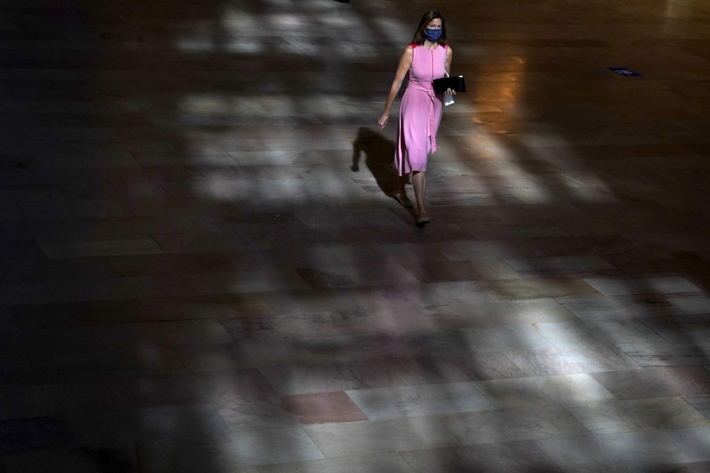 A woman walks through Grand Central Terminal in New York on August 24. America’s abysmal failure to contain the virus not only underscores the lingering fears of infection, but also raises the distinct possibility of a new wave of Covid-19 itself. Photo: AFP