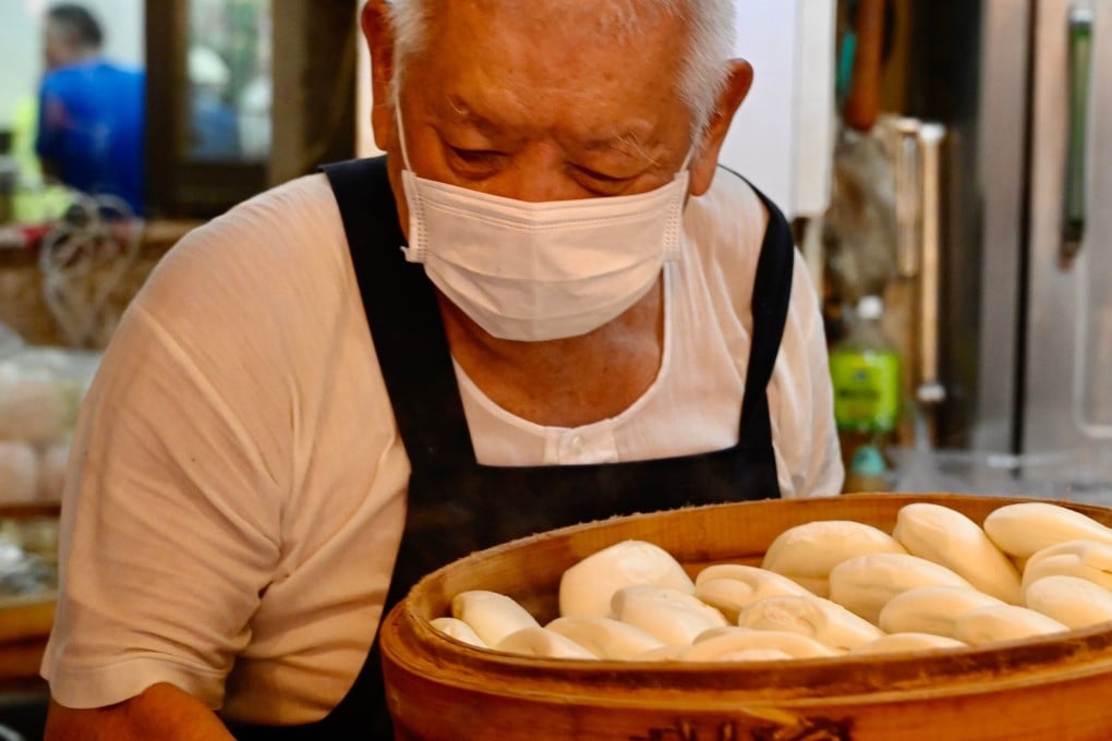 Wu Huang-yi, 80, brings out fresh baskets of guabao at his stall in Taipei’s Huaxi Street Night Market. Photo: AFP