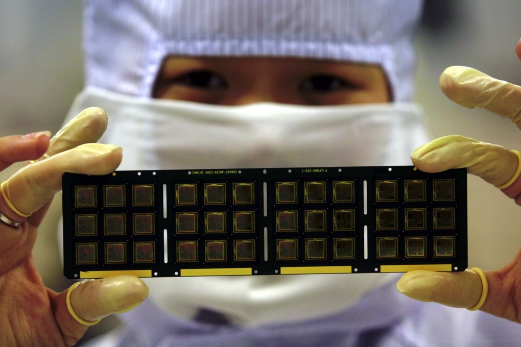 A worker of Infineon Technologies, one of Europe’s largest semiconductor companies, displays some of the German firm’s products. Chip makers Infineon, STMicroelectronics, AMS and Dialog Semiconductor are assessing the latest US government sanctions against Huawei Technologies. Photo: AP