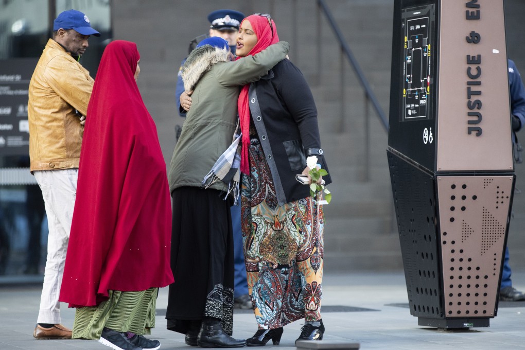 Victims and relatives embrace as they wait to enter the Christchurch High Court for the final day in the sentencing hearing for Australian Brenton Harrison Tarrant. Photo: AP