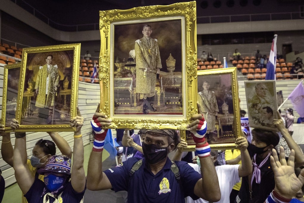 Supporters of the Thai monarchy hold up images of King Maha Vajiralongkorn and the late King Bhumibol Adulyadej during a rally in Bangkok on Sunday. Photo: AP