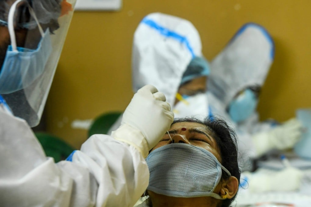 A health worker collects a swab sample for Covid-19 testing from a woman in Kolkata on August 23. Photo: AFP