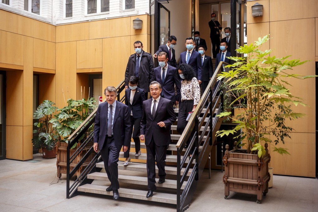 Chinese Foreign Minister Wang Yi (right) prepares to make a statement at the French Institute for International Relations in Paris on Sunday. Photo: AP
