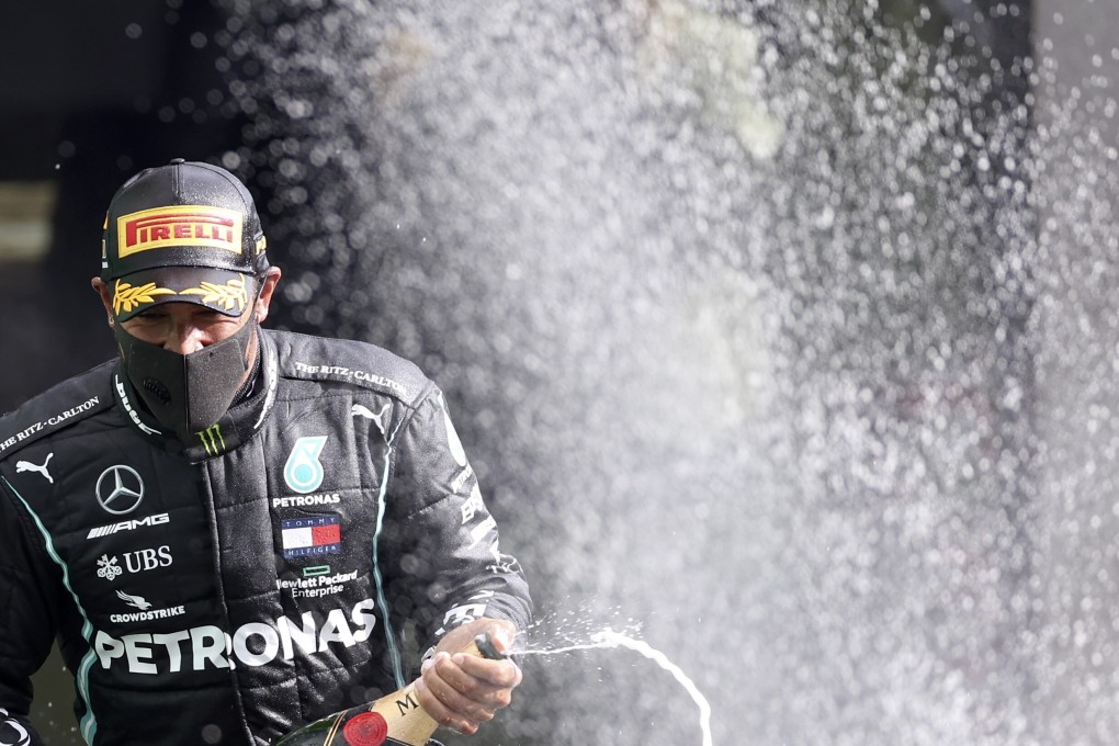 Mercedes driver Lewis Hamilton sprays champagne as he celebrates on the podium after winning the Belgian Grand Prix. Photo: AP