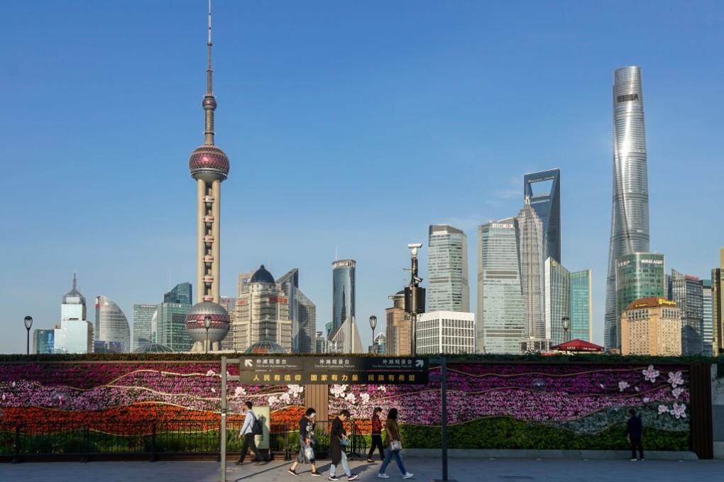 People wearing face masks walk along the Bund in Shanghai. Virtual tours to such popular tourist areas, and other major attractions in China such as the Great Wall and Forbidden City, are helping many guides survive the pandemic. Photo: VCG via Getty Images