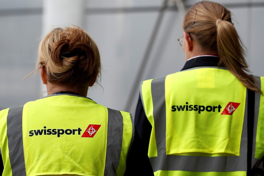 Swissport airport workers walk across the tarmac at Liverpool John Lennon Airport in northern England, in May, 2016. Photo: Reuters