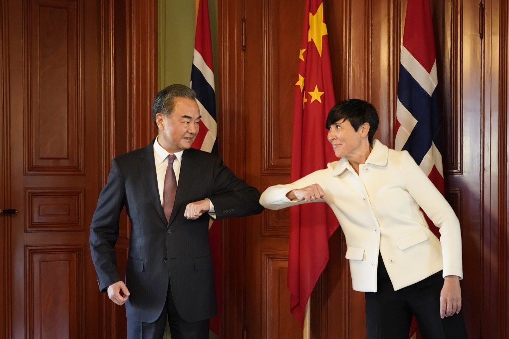 Chinese Foreign Minister Wang Yi greets his Norwegian counterpart Ine Eriksen Soreide with an elbow bump in Oslo on Thursday. Wang is on a five-nation tour of Europe. Photo: Xinhua