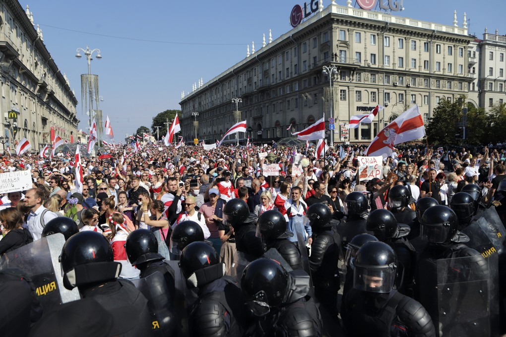 Police block the way for Belarusian opposition supporters as thousands protest in the centre of Minsk on Sunday, August 30. Photo: AP