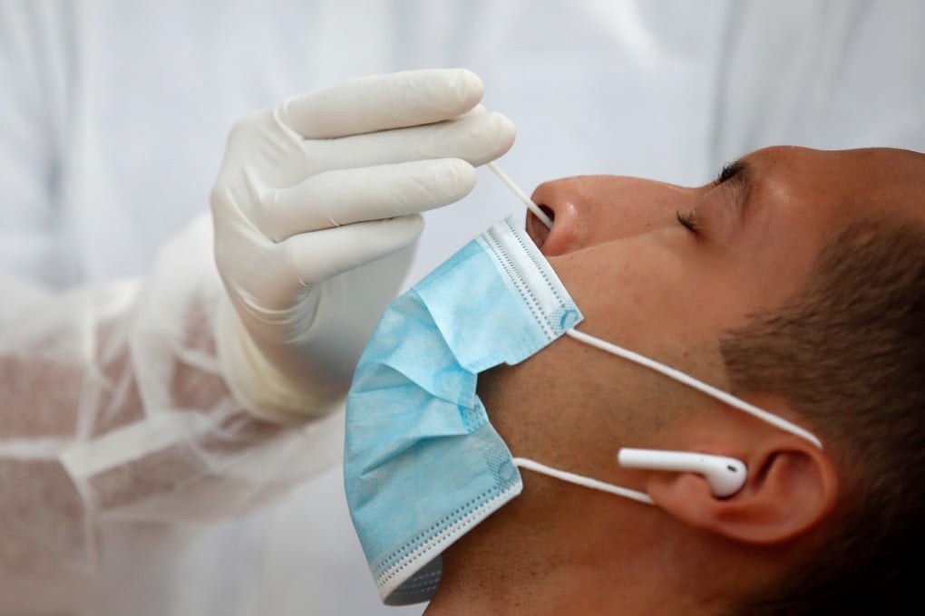 A health worker administers a nasal swab test in Paris, France. Photo: Reuters