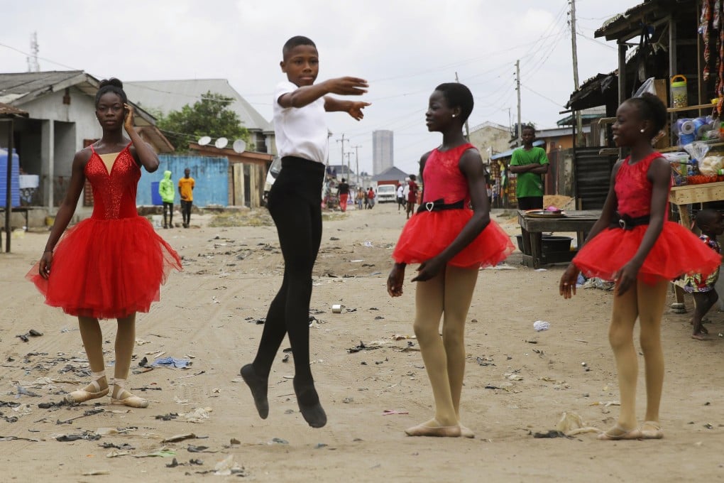 Ballet student Anthony Mmesoma Madu dances in the street as fellow dancers look on in Lagos, Nigeria. After a video of him dancing went viral, Anthony earned a scholarship from the prestigious American Ballet Theatre in New York. Photo: AP