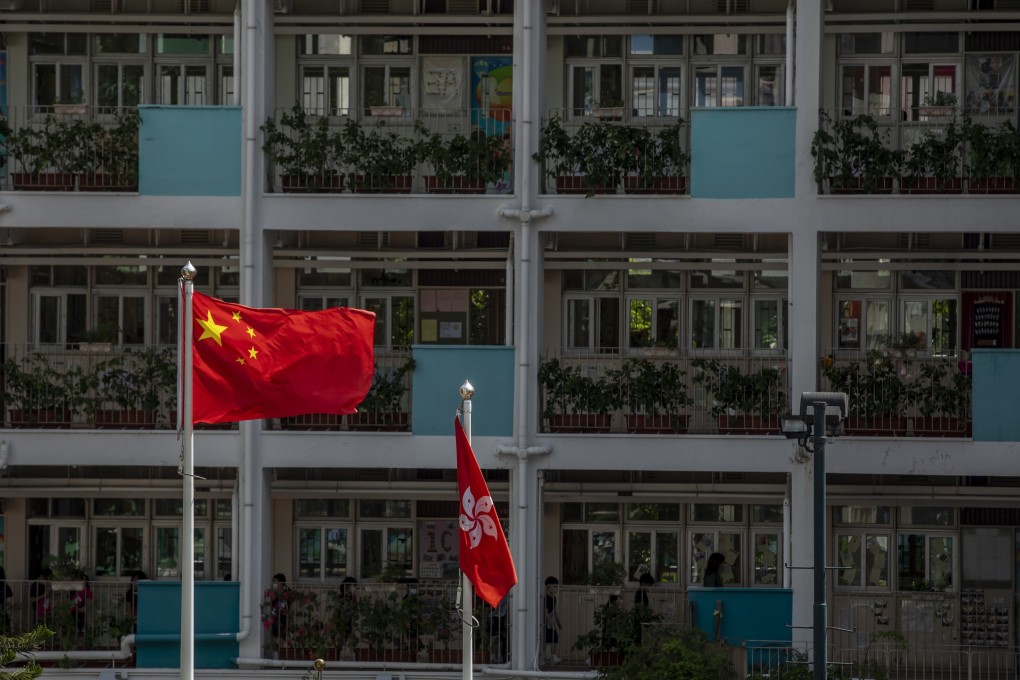 The flags of China and Hong Kong are flown at a school in Hong Kong. Photo: Bloomberg