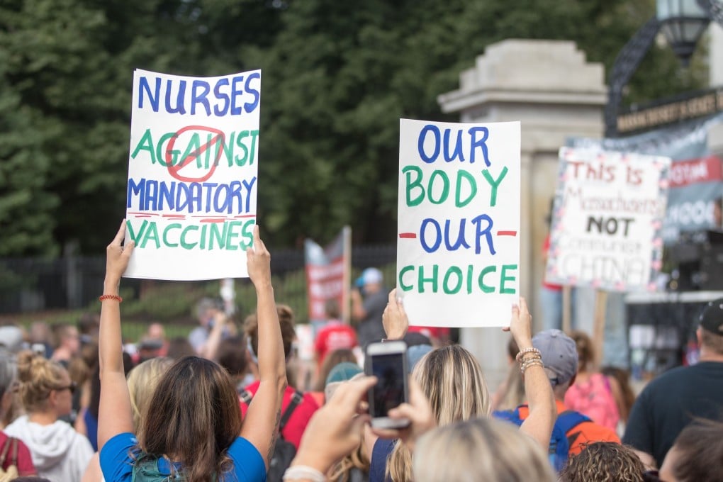 Anti-vaccine activists hold up signs during a protest in the US state of Massachusetts on August 29. Photo: AFP