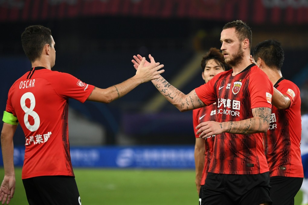 Marko Arnautovic of Shanghai SIPG celebrates with Oscar after scoring in the 4-1 Chinese Super League win over Tianjin Teda. Photo: Xinhua