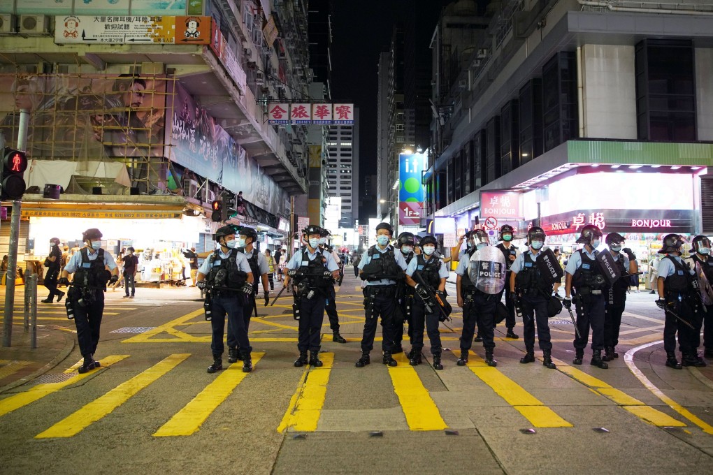 Police officers stand by to stop and search people around Mong Kok on the first anniversary of the August 31 incident at Prince Edward MTR station. Photo: Winson Wong