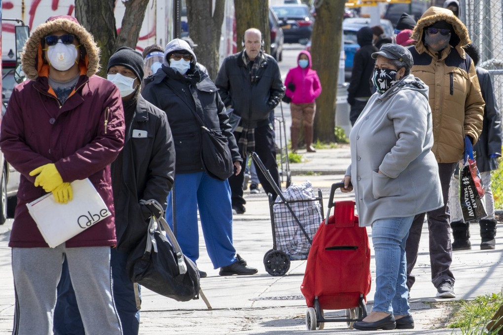 People queue for food handouts in Brooklyn, New York. The coronavirus pandemic has brought hard times for many millions in cities. File photo: AP