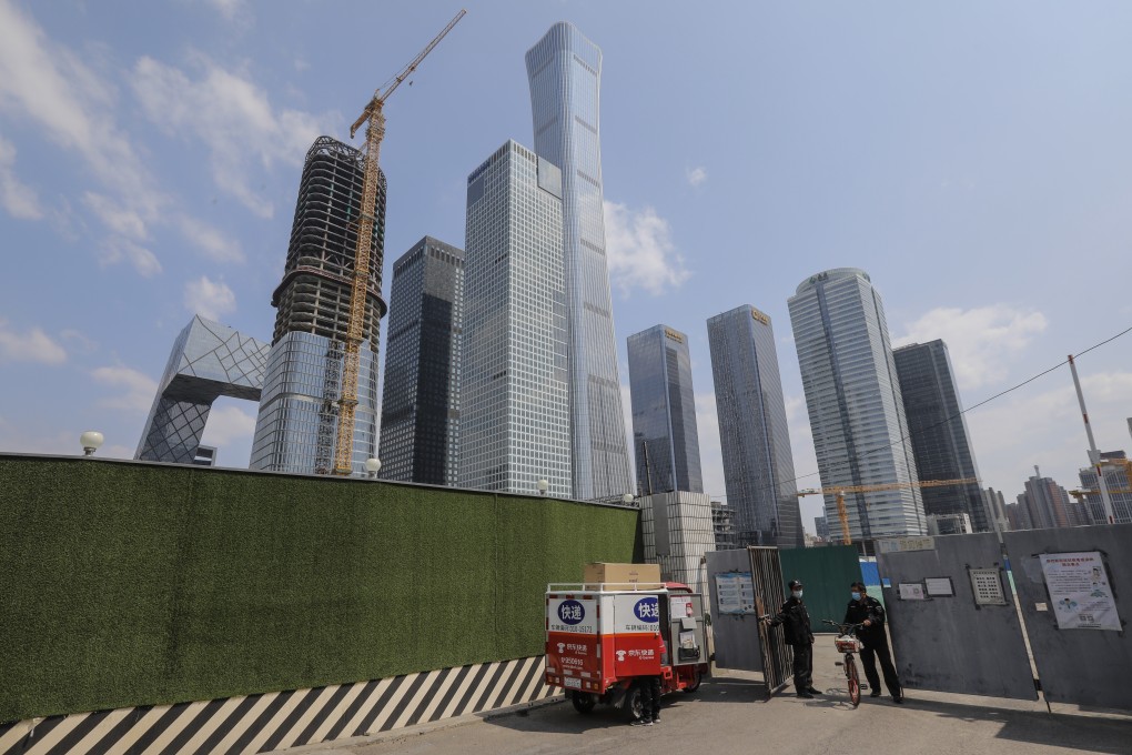 A security guard walks out of from a suspended construction field in the central business district in Beijing in April 2020. Photo: EPA-EFE