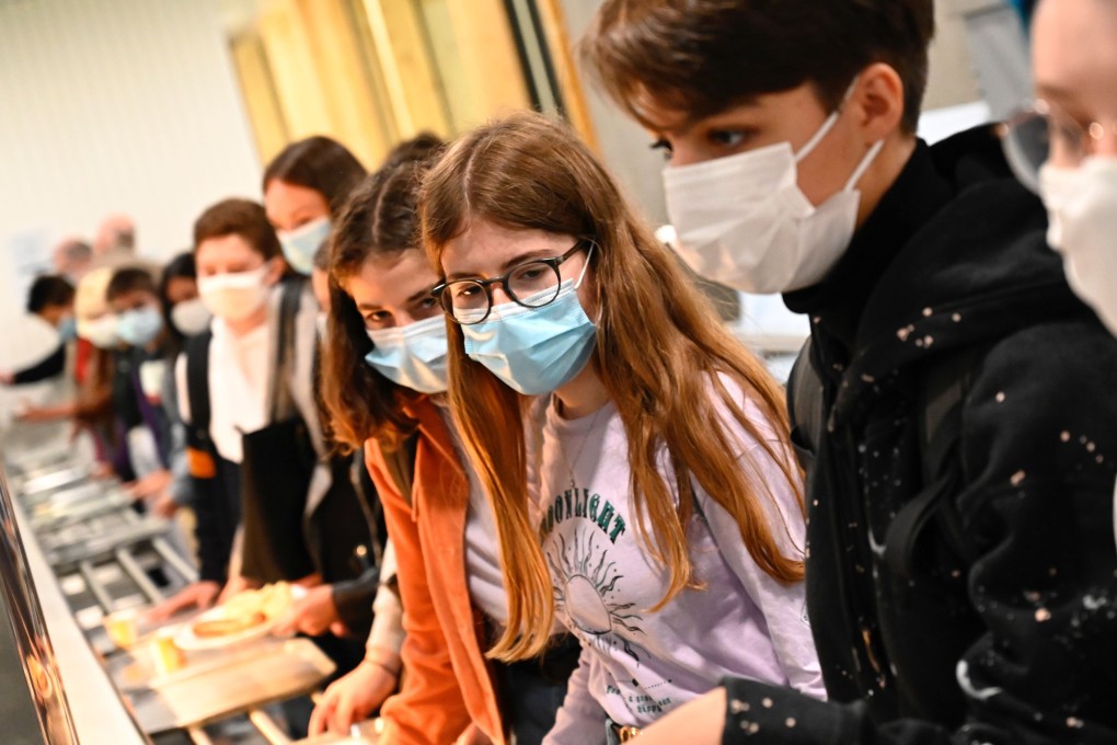 Pupils wearing protective masks queue at the cafeteria in Brequigny high school in Rennes. Photo: AFP