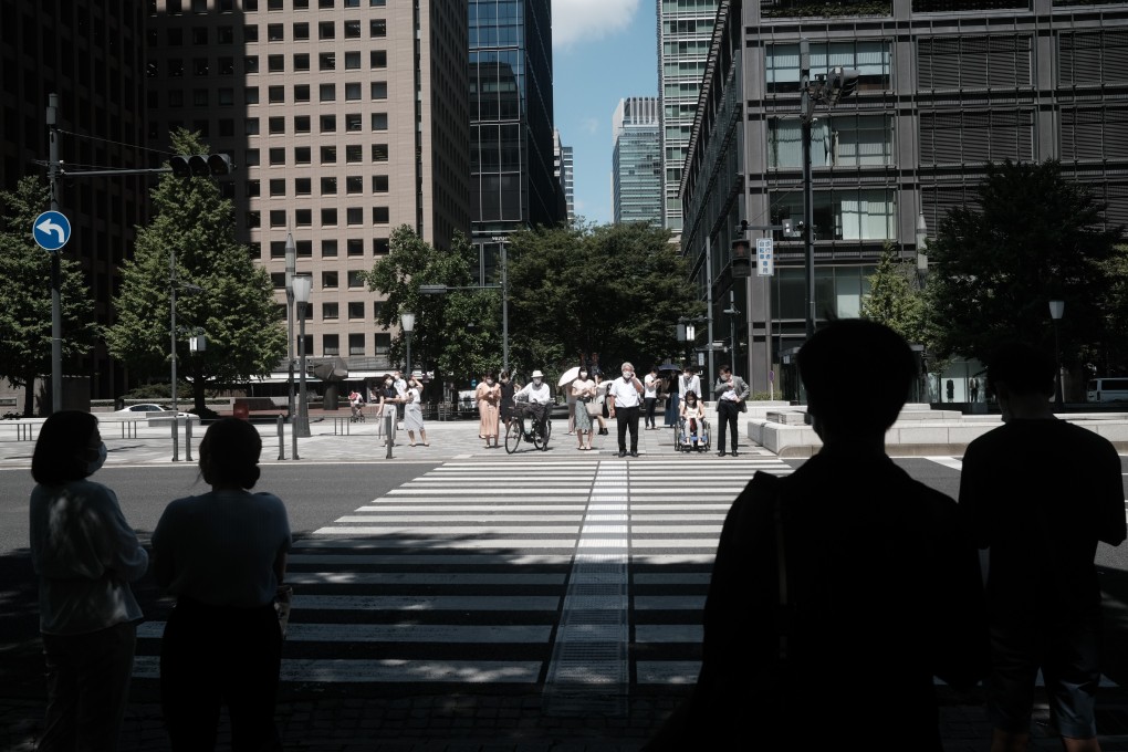 People wait to cross a road in the Marunouchi district of Tokyo on August 28. The coronavirus crisis has given Abenomics a new lease of life, and the programme is unlikely to be reversed. Photo: Bloomberg