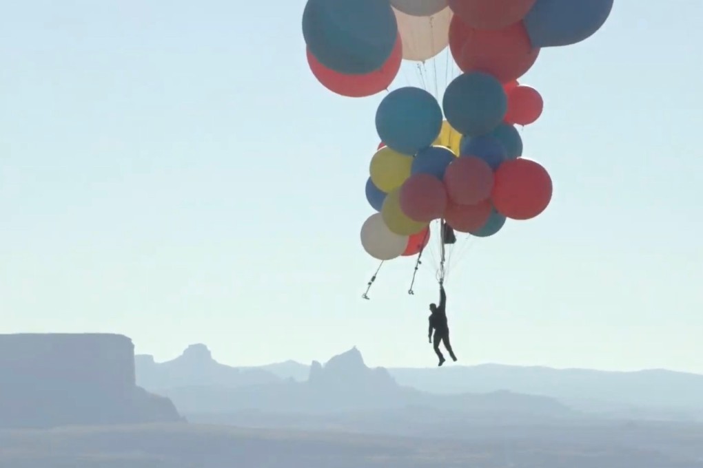 Magician David Blaine hangs from a parachute under a cluster of balloons while performing his “Ascension” stunt in Page, Arizona, on Wednesday. Photo: David Blaine handout via Reuters