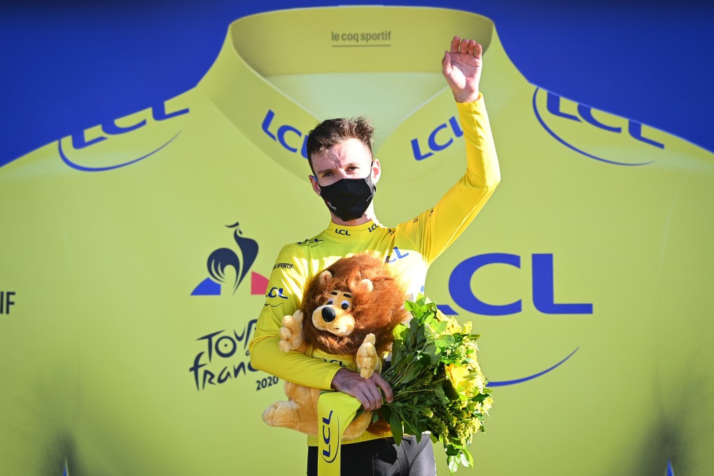 British cyclist Adam Yates of team Mitchelton-Scott celebrates on the podium in the yellow of overall leader after the 5th stage of the 107th edition of the Tour de France. Photo: DPA