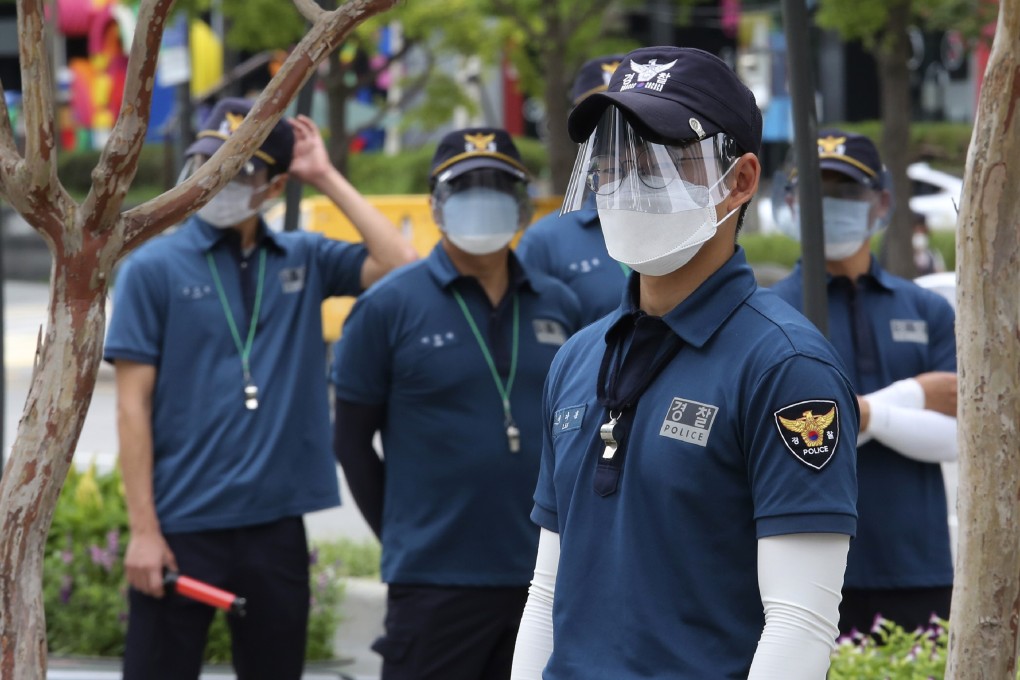 South Korean police officers wearing face masks and shields stand guard at Gwanghwamun Square in Seoul. Photo: AP