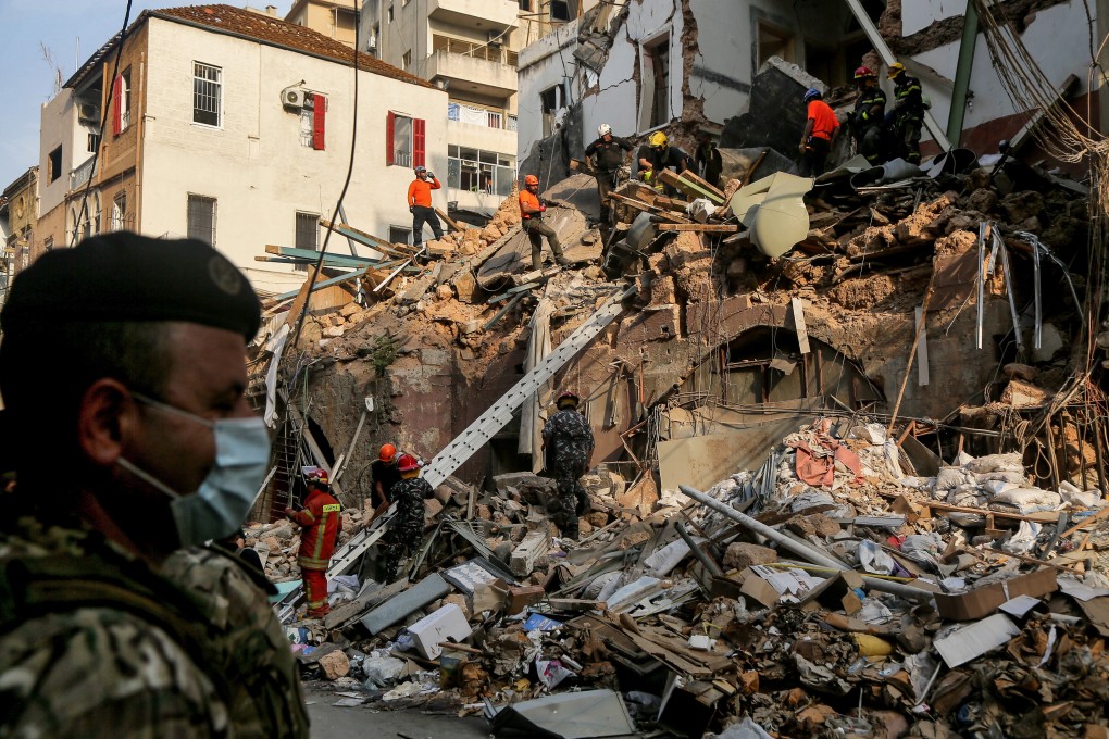 Members of the Chilean rescue team and Lebanese civil defence search the rubble of a building in Beirut on Thursday. Photo: dpa