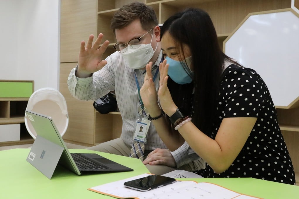 Teachers Joshua Aebig and Erin Chan lead an online lesson on the first day of school at a primary school in Yau Tong. Photo: K. Y. Cheng