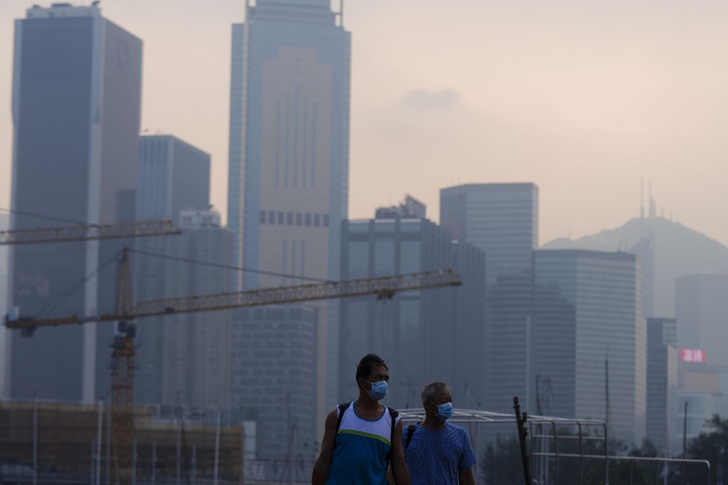 People walk in Causeway Bay on Tuesday as the Air Quality Health Index recorded “very high” air pollution levels. Photo: Sam Tsang
