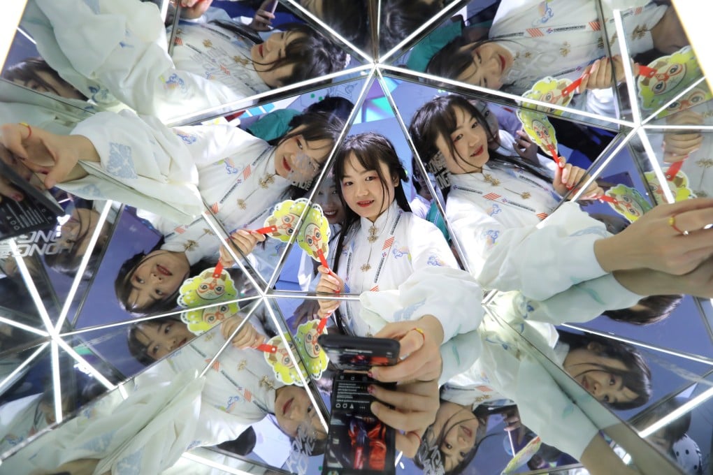 Visitors take selfies at the China International Fair for Trade in Services in May 2019. Photo: Simon Song