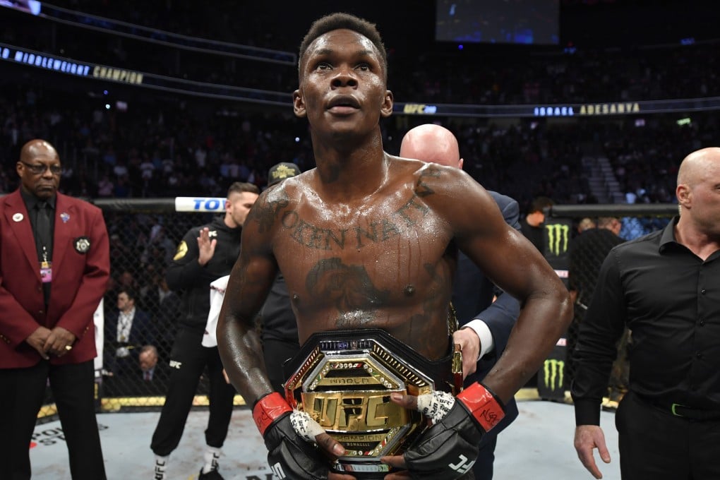 Israel Adesanya shows off his belt after defeating Yoel Romero in their UFC middleweight championship fight at UFC 248 in Las Vegas. Photo: Jeff Bottari/Zuffa LLC)