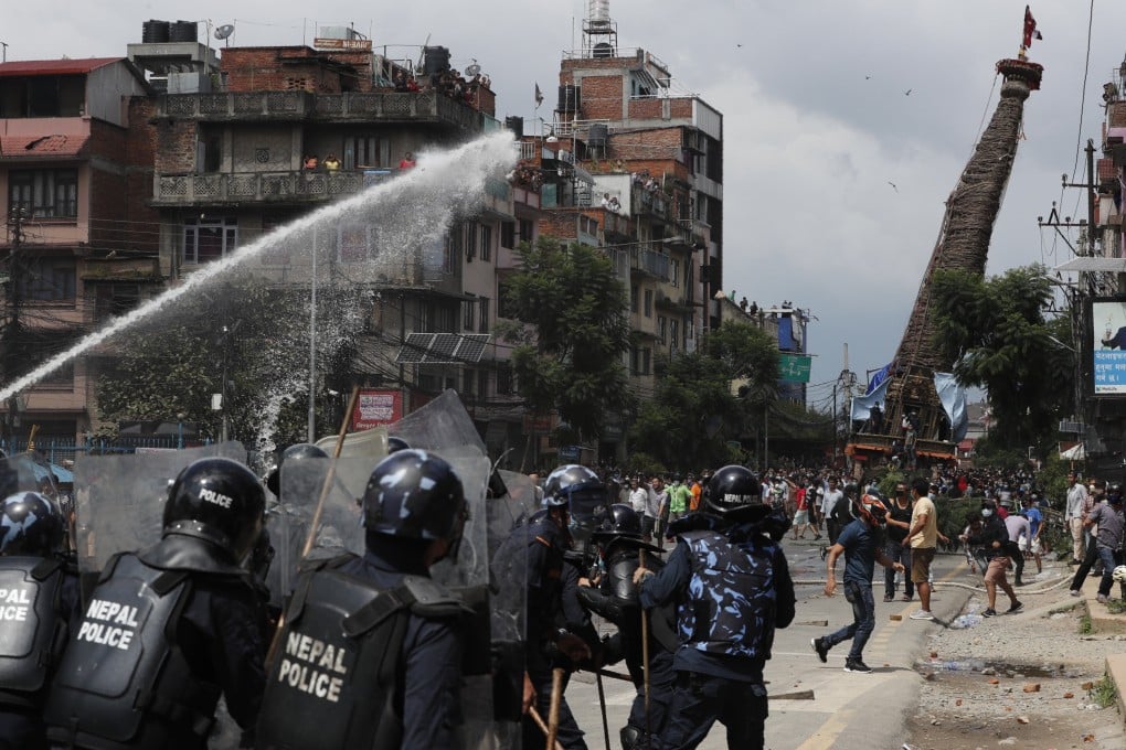 Protesters defying a government coronavirus lockdown to take part in a religious festival clash with riot police, in Lalitpur, Nepal, on Thursday. Photo: AP