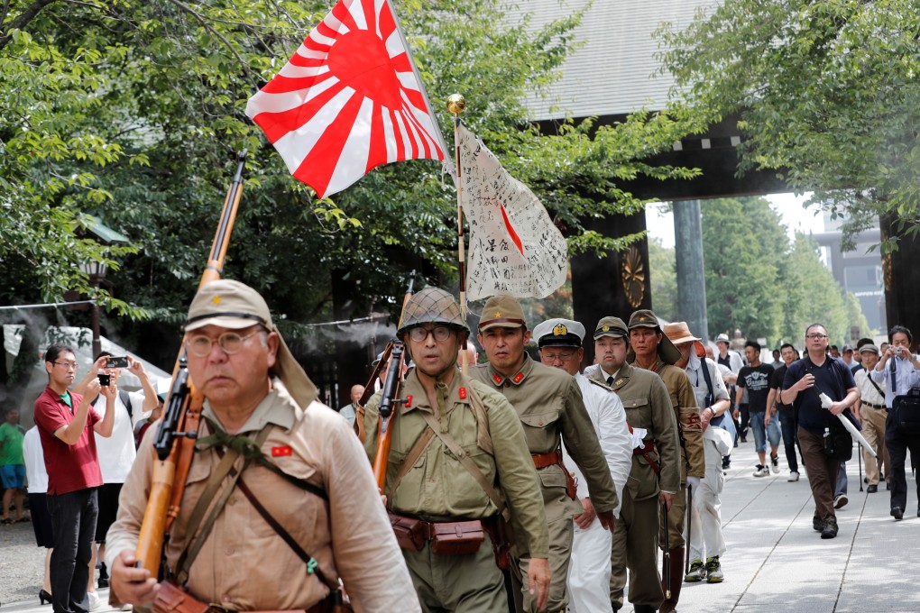 Men wearing Japanese imperial military uniforms visit the controversial Yasukuni Shrine in Tokyo to mark the 74th anniversary of Japan’s WWII surrender in 2019. Photo: Reuters