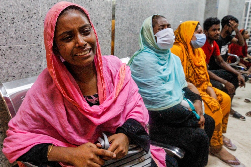Relatives of victims of a gas explosion are seen in a hospital in Dhaka. Dozens suffered life-threatening burns, police said. Photo: AFP