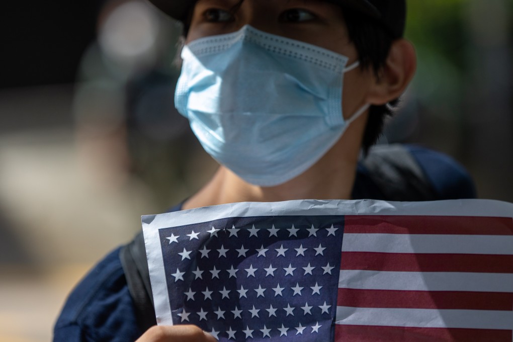A man holds up a US flag outside the US Consulate General in Hong Kong on Independence Day on July 4. Photo: EPA-EFE