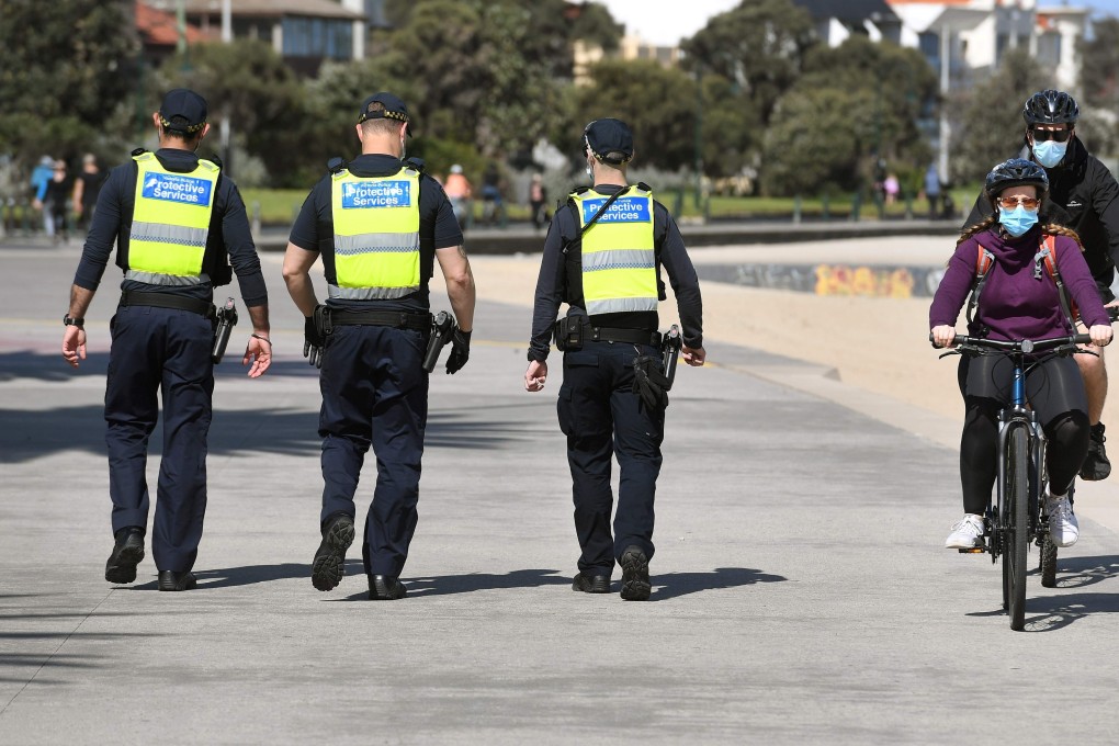 Protective services officers patrol along the St Kilda Beach foreshore in Melbourne as the city battles an outbreak of the coronavirus. Photo: AFP