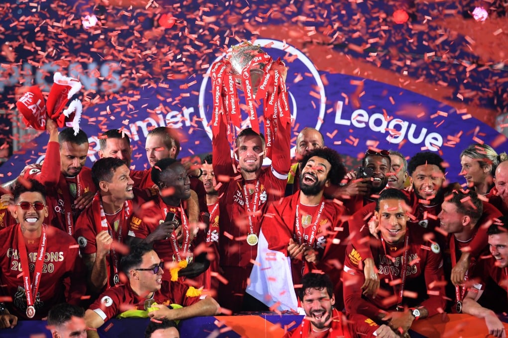 Liverpool's Jordan Henderson lifts the English Premier League trophy after playing Chelsea. The game was not shown on Chinese terrestrial television as scheduled. Photo: DPA