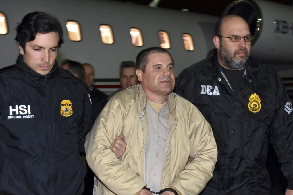 Authorities escort Mexican drug lord Joaquin “El Chapo” Guzman from a plane in Ronkonkoma, NY on September 4, 2020. Photo: US law enforcement via AP