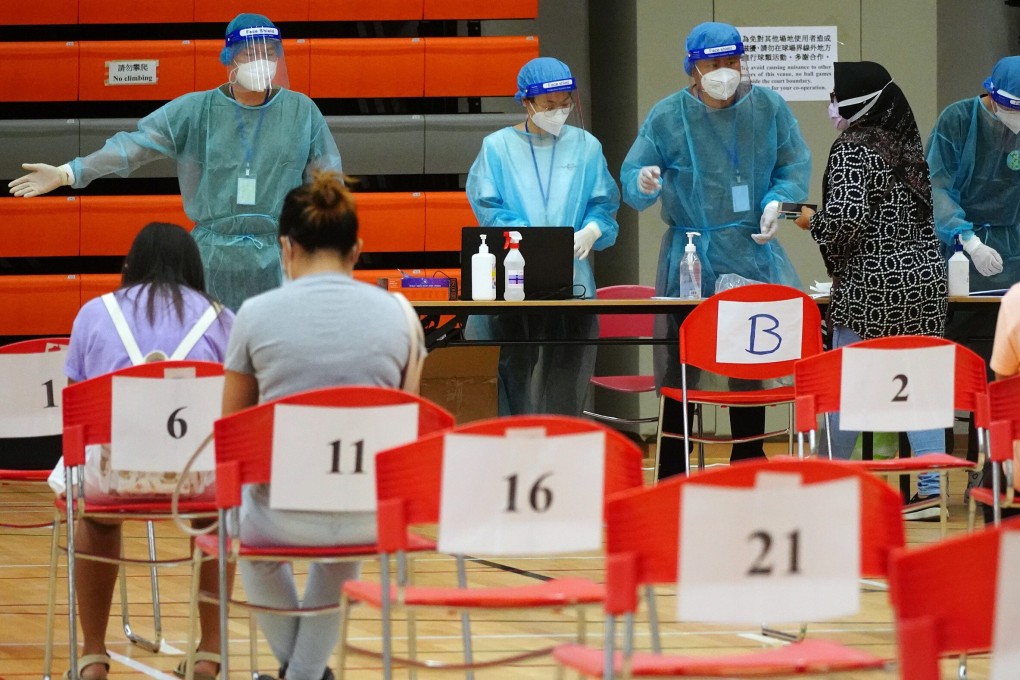 Domestic helpers wait to be tested at the Harbour Road Sports Centre in Wan Chai. Photo: Sam Tsang