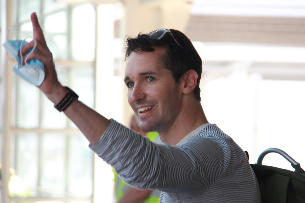 Australian Broadcasting Corporation journalist Bill Birtles waves as he arrives in Sydney after leaving China over arrest fears, amid worsening diplomatic relations between the two countries. Photo: AFP