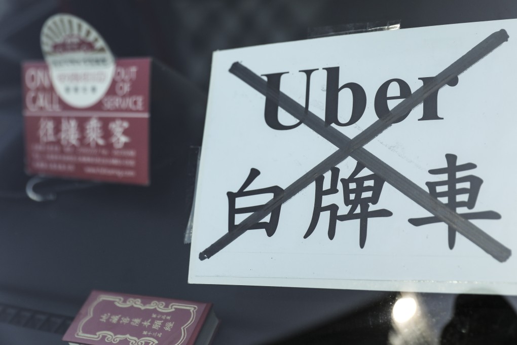 A message reading “Uber Out” on a taxi during a protest against Uber and other unlicensed passenger services in February. Photo: Winson Wong