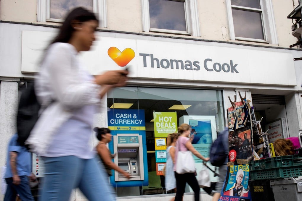 Pedestrians are pictured walking past a branch of a Thomas Cook travel agent's shop in London in September 2019 before it went into administration. Photo: AFP