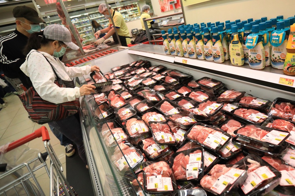 Shoppers examine pork for sale at a Wellcome supermarket in Causeway Bay in April. Photo: May Tse