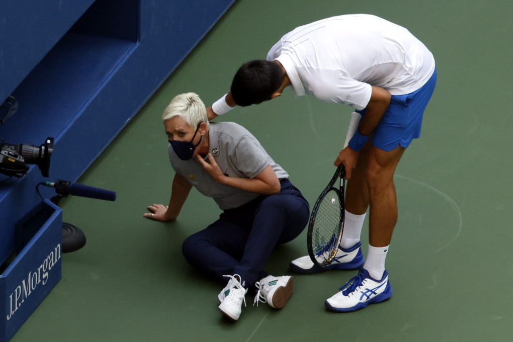 Novak Djokovic goes to help the line judge after hitting her with a ball in the throat during his match against Pablo Carreno Busta at the US Open. Photo: EPA