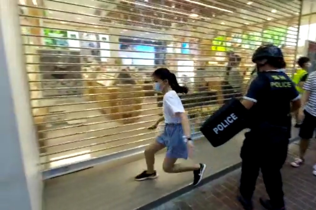 Hong Kong police officer tackles and pins 12-year-old girl to ground during anti-government rally.