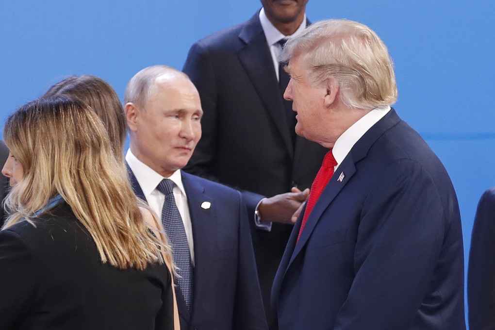 US President Donald Trump (right) walks past Russia’s President Vladimir Putin as they prepare for a group photo at the start of the G20 summit in Buenos Aires in November 2018. Photo: AP