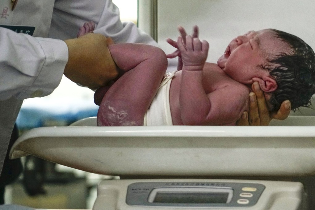 A newborn is weighed at a hospital in China’s Hebei province. Photo: Xinhua