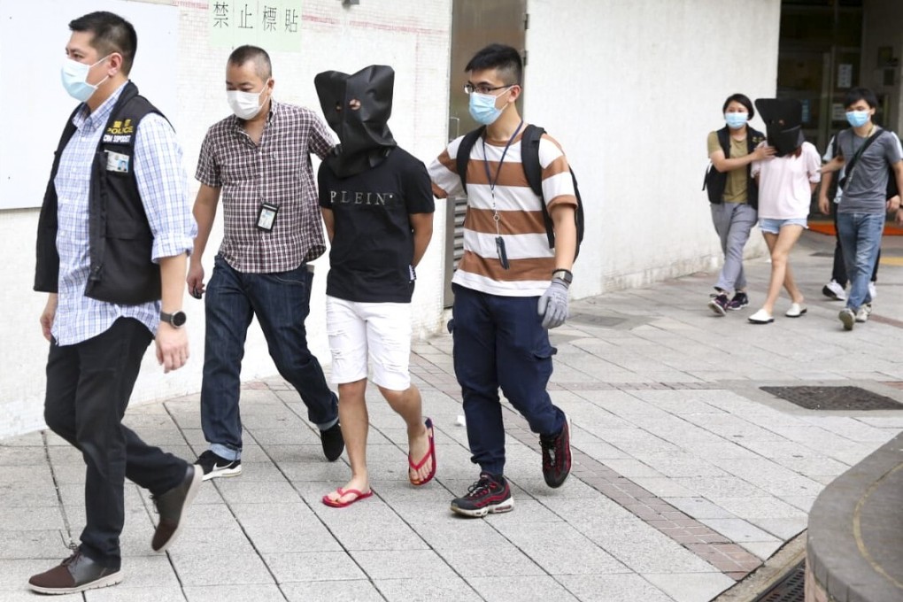 Police with the suspects accused of taking part in the dognapping. Photo: Handout