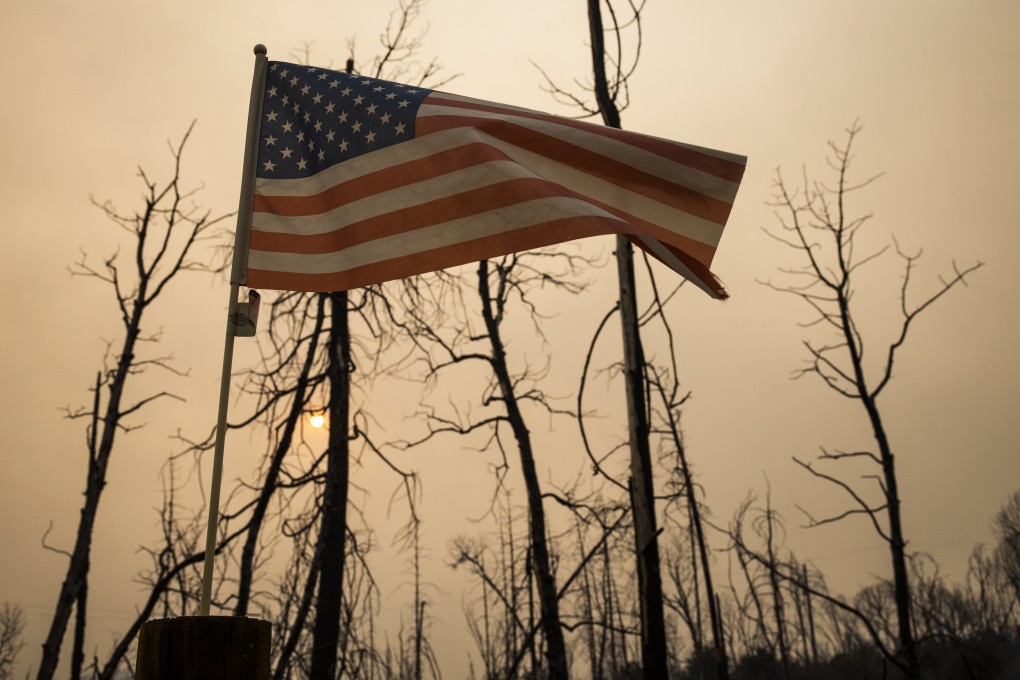 A US flag flies in Feather Falls, California, on Thursday after a forest fire tore through the area. Photo: EPA