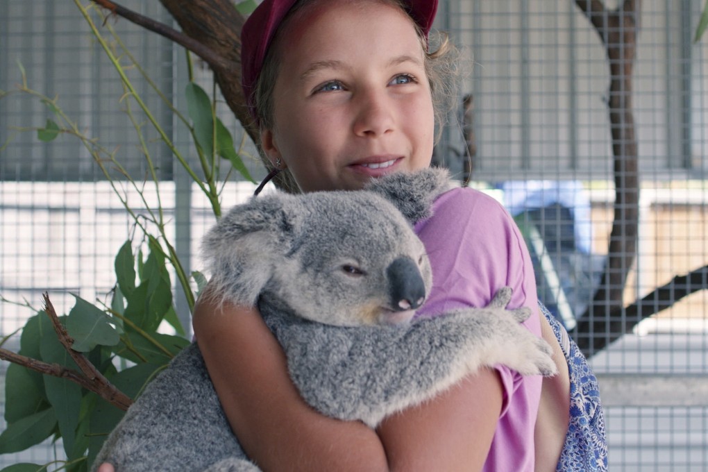 Izzy Bee holds a koala bear in a scene from Netflix’s Izzy’s Koala World, which follows the 11-year-old girl as she helps her veterinary surgeon mother take care of koalas. Photo: AP