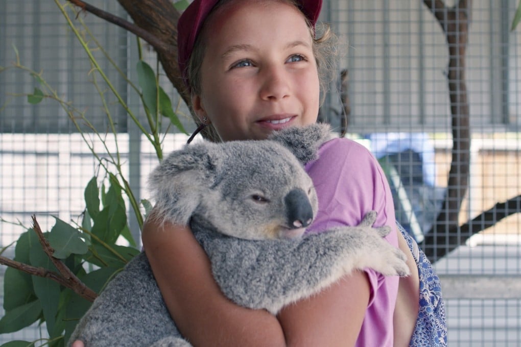 Izzy Bee holds a koala bear in a scene from Netflix’s Izzy’s Koala World, which follows the 11-year-old girl as she helps her veterinary surgeon mother take care of koalas. Photo: AP